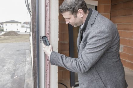 Muž skenuje QR kód na okne